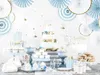 A dessert table setup with a tiered cake, cupcakes, cookies, and decorative elements. Náhled obrázku produktu