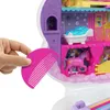 A hand holding a pink comb near a toy unicorn playset. Produktbild-Vorschau