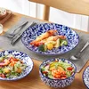 A table setting with plates of food, cutlery, and a placemat. Produktbild-Vorschau