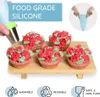 Decorated cupcakes on a wooden stand, with text overlays and icons. Anteprima dell’immagine prodotto