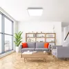 A modern living room with a sofa, coffee table, and shelves. Produktbild-Vorschau