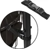 A close-up view of a black strap with a buckle attached to a black pole and a brown fabric item, likely a hanging chair or swing. Produktbild-Vorschau