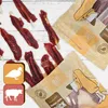 A flat lay of dog treats, some loose and some in packaging, on a white wooden surface. Anteprima dell’immagine prodotto