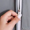 A hand is zipping up a gray garment bag. Produktbild-Vorschau