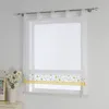 A white window with sheer curtains and a roman blind with a floral pattern. Produktbild-Vorschau
