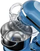 A close-up view of a blue stand mixer with a whisk attachment inside a stainless steel bowl. Produktbild-Vorschau