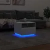 A modern living room scene with a couch and a white LED-lit side table. Voir les images du produit
