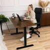 A woman is working at a standing desk in a home office setting. Náhled obrázku produktu