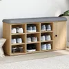 A shoe bench with storage compartments and a padded seat, placed on a floor with a rug. Anteprima dell’immagine prodotto