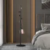 A modern bedroom with a coat rack and a bed. Produktbild-Vorschau