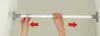 Hands adjusting a telescopic rod mounted between two walls. Produktbild-Vorschau