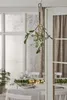 A mistletoe decoration with LED lights hangs in a doorway, with a dining table set for a meal visible in the background. Podgląd zdjęcia produktu