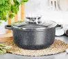 A speckled black pot with a glass lid sits on a woven placemat on a kitchen counter. Produktbild-Vorschau