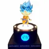 A Goku figurine on a black alarm clock base with a digital display. Voir les images du produit