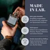 A person is holding a perfume bottle with text and icons describing product features. Podgląd zdjęcia produktu