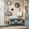 An entryway with a shoe cabinet, bench, clock, hat, and bags. Náhled obrázku produktu