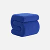 A blue bouclé ottoman is shown against a white background. Produktbild-Vorschau
