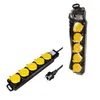 Two black power strips with yellow outlets are shown against a white background. One is laid out flat with its plug visible, and the other is standing upright and partially wrapped in plastic. Produktbild-Vorschau