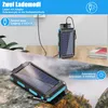 A solar power bank is shown in two different scenarios: one plugged into a wall outlet and another being charged by the sun outdoors. Produktbild-Vorschau