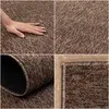 A collage of four images showing different views of a brown rug, including a hand touching it, a close-up of the texture, and a rolled-up corner. Náhled obrázku produktu