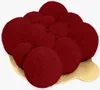 A close-up, top-down view of a red velvet cake on a gold cake board. Produktbild-Vorschau