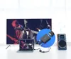 A Ugreen HDMI to VGA converter is shown connected to a laptop, which is displaying a concert scene. The converter is also shown with a VGA connector and a 3.5mm audio jack, suggesting it can output audio to a speaker, which is also depicted in the image. Voir les images du produit