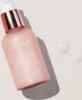 A bottle of medicube Triple Collagen Serum is shown on a light-colored surface with two drops of serum next to it. Podgląd zdjęcia produktu