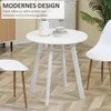 A white round dining table with two white chairs and a vase and cup on top, in a room with wooden flooring. Produktbild-Vorschau