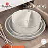 A set of nesting pots with a detachable handle stored neatly in a kitchen drawer. Produktbild-Vorschau