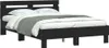 A black wooden bed frame with a headboard, shown with white bedding and a grey throw blanket. Anteprima dell’immagine prodotto