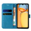 A blue flip phone case is open, showing a phone screen with an abstract colorful image, credit cards, and a banknote. Produktbild-Vorschau