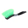 A green brush with a black and gray handle is shown against a white background. Produktbild-Vorschau