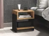 A bedside table with items on and in it, next to a bed. Produktbild-Vorschau