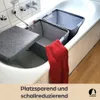 Two grey felt laundry baskets are placed in a bathtub, with a red towel draped over one of them. A grey lid is placed on one of the baskets. Produktbild-Vorschau