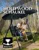 A woman and a child are sitting on a black Hollywood swing in a wooded area. Produktbild-Vorschau