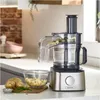 A food processor is shown on a kitchen counter, with chopped potatoes in a bowl next to it. Produktbild-Vorschau