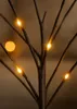 A close-up shot of dark branches with small, warm white LED lights attached. Produktbild-Vorschau