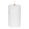 A white LED candle with a ribbed texture and a flame-like LED light on top, shown against a white background. Podgląd zdjęcia produktu