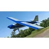 A model airplane is flying in the sky with trees and a grassy hill in the background. Produktbild-Vorschau