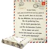 A folded blanket with a letter design is shown next to an unfolded blanket with the same design. Produktbild-Vorschau
