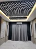 A room with acoustic panels on the ceiling and walls, a large window with curtains, and an air conditioning unit. Podgląd zdjęcia produktu