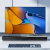 A television screen displaying abstract art, a soundbar below it, and a keyboard in front. Produktbild-Vorschau