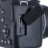 A close-up view of the side ports of a black digital camera. Náhľad obrázku produktu