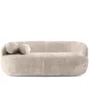 A modern, beige sofa with organic curves and two round decorative pillows, presented against a white background. Produktbild-Vorschau