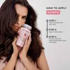 A woman holding a bottle of Kerastase Genesis shampoo, with instructions on how to apply it. Produktbild-Vorschau