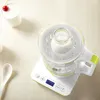 A yogurt maker with a small glass jar filled with yogurt inside, placed on a white digital scale. Anteprima dell’immagine prodotto