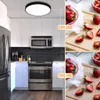A split image showing a modern kitchen with stainless steel appliances and white cabinets on the left, and close-ups of fresh strawberries on a wooden board on the right. The kitchen scene is illuminated by a ceiling light. Produktbild-Vorschau