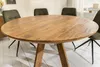 A round wooden dining table with four chairs around it, in a brightly lit room with white wooden floorboards. Produktbild-Vorschau