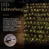 A string of LED lights is draped over a bush, creating a magical atmosphere. Produktbild-Vorschau