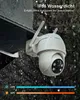 A white security camera is mounted outdoors in the rain, with water droplets on its surface. The background shows trees and foliage, suggesting an outdoor environment. Text overlays highlight its IP66 waterproof rating and temperature range. Produktbild-Vorschau